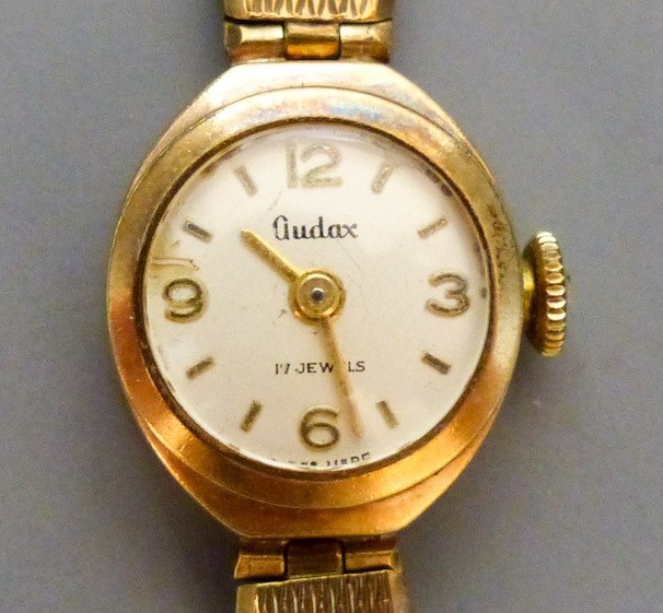 A lady's Audax 9ct gold manual wind wrist watch, on a 9ct gold bracelet